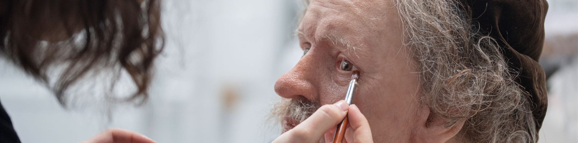 woman applying special effects makeup
